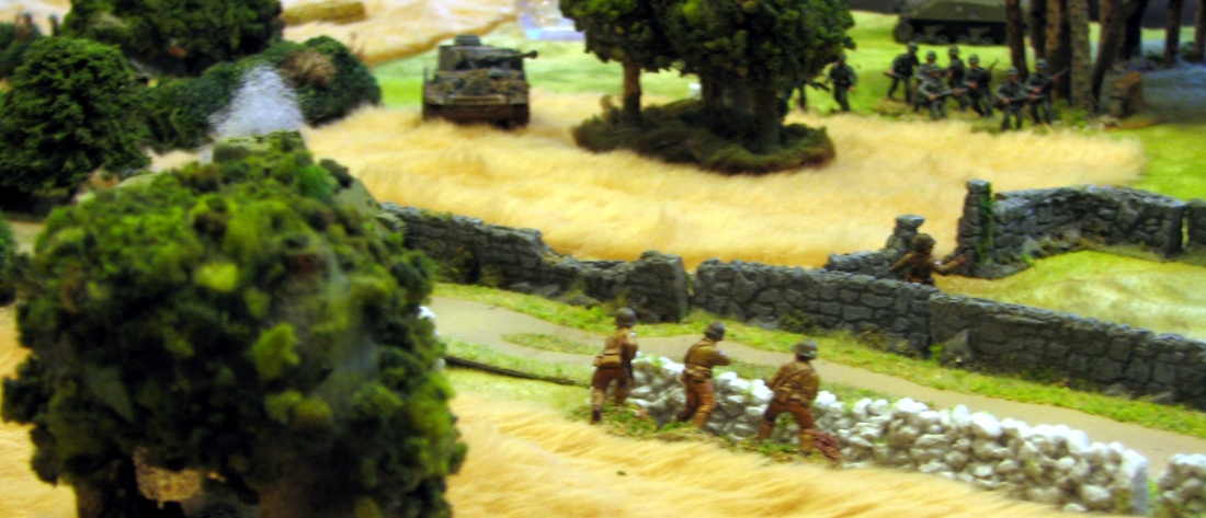 The puff of smoke rising above the tree tells the grim tale of another Sheran knocked out. The battered remnants of the first US section grimly await the coming onslaught